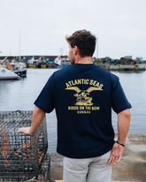 Man wearing a navy blue t-shirt with &